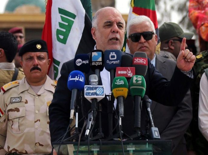 A handout picture released by the Iraqi Prime Minister's office shows Iraqi Prime Minister Haider al-Abadi (C) delivering a spech to Iraqi soldiers and Sunni volunteers at Habbaniyah base in eastern Ramadi city, west of Iraq, 08 April 2015. Al-Abadi arrived in Ramadi city and met with local officials and announced that the next battle will be in Anbar province. Media reports state that the prime minister visited the Habbaniyah base to see the preparations for the Liberation of the province from the control of Islamic state militia (IS) and distributed weapons to Sunni volunteers who will participate in the liberation of Anbar province from the control of Islamic state fighters. EPA/IRAQI PRIME MINISTER OFFICE / HANDOUT