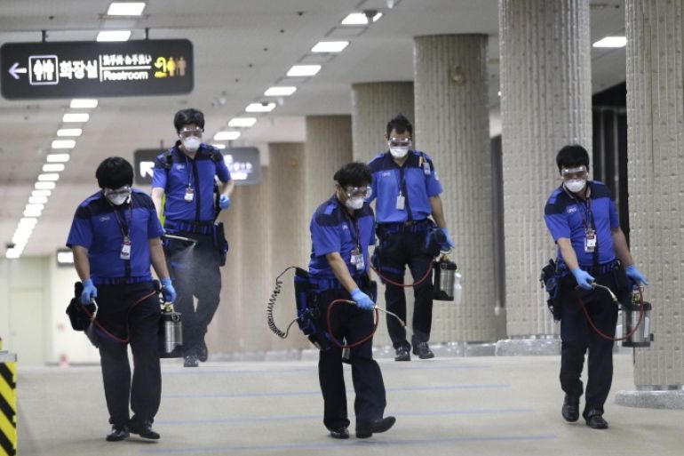 Workers wearing masks and goggles, spray disinfectant as a precaution against the spread of Middle East Respiratory Syndrome virus at Gimpo International Airport in Seoul, South Korea Wednesday, June 17, 2015. The South Korea's MERS outbreak originated from a 68-year-old man who had traveled to the Middle East, where the illness has been centered, before being diagnosed as the country's first MERS patient last month. (AP Photo/Lee Jin-man)