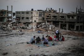 GAZA CITY, GAZA - JUNE 19: Muslim Palestinians break their fest amid the debris of buildings destroyed in the Israeli attacks in the Shajaiya neighborhood, Gaza Strip in Islam's holy fasting month of Ramadan on June 19, 2015.