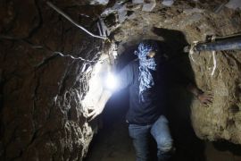 A Palestinian works inside a smuggling tunnel flooded by Egyptian forces, beneath the Egyptian-Gaza border in Rafah, in the southern Gaza Strip February 19, 2013. Egypt will not tolerate a two-way flow of smuggled arms with the Gaza Strip that is destabilising its Sinai peninsula, a senior aide to its Islamist president said, explaining why Egyptian forces flooded sub-border tunnels last week. To match Interview PALESTINIANS-TUNNELS/EGYPT/ REUTERS/Ibraheem Abu Mustafa (GAZA - Tags: POLITICS CIVIL UNREST)