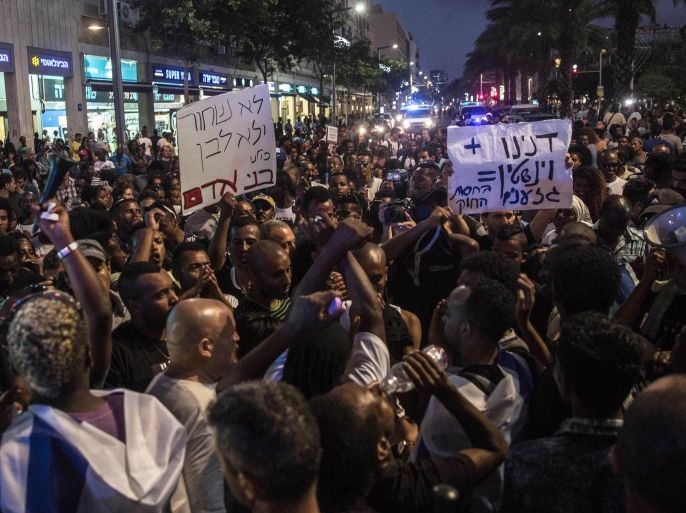 Ethiopian Jewish men chant during a protest in Tel Aviv, Israel, Monday, June 22, 2015. Israel's Jewish Ethiopian minority protested in Tel Aviv against racism and police brutality Monday weeks after an Ethiopian Israeli soldier was beaten by the police. (AP Photo/Tsafrir Abayov)