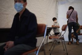 People wait in a tent prior to being tested for Middle East Respiratory Syndrome (MERS) outside the Seoul Medical Center prior to a government-organised media tour, in Seoul on June 10, 2015. South Korean President Park Geun-Hye has postponed a planned trip to the US, her spokesman said, amid growing public alarm over the MERS outbreak which has now claimed nine lives. AFP PHOTO / Ed Jones