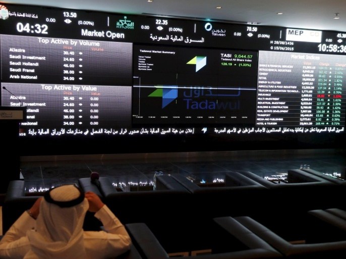 A trader monitors screens displaying stock information at the Saudi Stock Exchange (Tadawul) in Riyadh June 15, 2015. The chief executive of Saudi Arabia's stock exchange said on Monday he expected a flurry of licenses allowing the first foreign investors to buy shares there in coming weeks. To match Interview SAUDI-STOCKEXCHANGE/ REUTERS/Faisal Al Nasser
