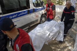 Rescuers carry the body of a tourist who was shot dead by a gunman at a beachside hotel in Sousse, Tunisia, June 26, 2015. A gunman disguised as a tourist opened fire at a Tunisian hotel on Friday with a weapon he had hidden in an umbrella, killing tourists, including those from Britain, Germany and Belgium, as they lounged at the beach and pool in the popular resort town. The death toll from the shooting attack has risen to 37, the health ministry said in a statement carried by state news agency TAP. REUTERS/Amine Ben Aziza