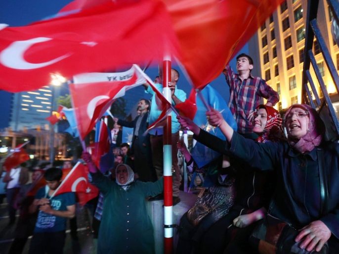 Supporters of Turkey's Islamic-rooted Justice and Development Party (AKP) wave Turkish flags as they celebrate the results of the legislative election outside the AKP's headquarters in Ankara, on June 7, 2015. AKP won the most votes in Sunday's election but has lost its parliamentary majority and will need to form a coalition, official results said. AFP PHOTO / ADEM ALTAN