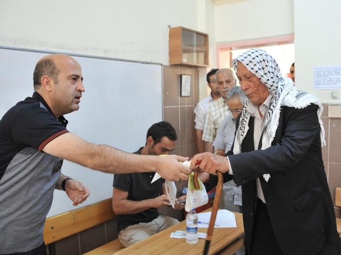 SANLIURFA, TURKEY - JUNE 07: A man casts his vote for the Turkish general election to elect the 550 members of the Grand National Assembly, in Sanliurfa southeast of Turkey on June 07, 2015.