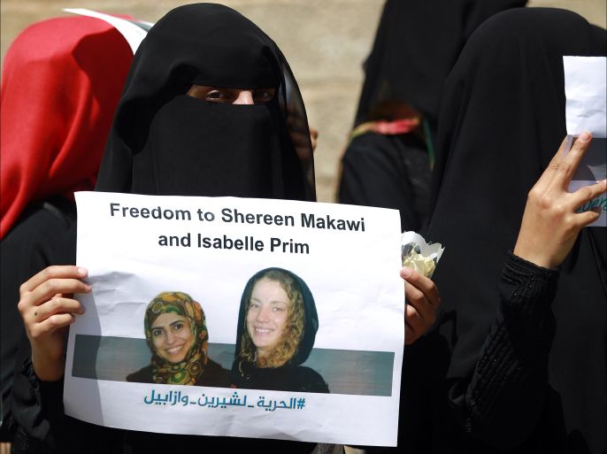 (FILES) -- A file photo taken on March 9, 2015 shows Yemeni women taking part in a rally in Sanaa calling for the release of French woman Isabelle Prime and her Yemeni interpreter Sherine Makkaoui who have been kidnapped last month in the capital by unidentified gunmen. The captors of Frenchwoman Isabelle Prime, kidnapped in Yemen on February 24, 2015 posted the first video of her since her abduction. In the 21-second tape posted on YouTube, Prime is shown seated on the ground dressed in black and appeals to the French and Yemeni presidents to take action to secure her release. The 30-year-old, who worked as a consultant on a World Bank-funded project, was seized with her translator Sherine Makkaoui as they were driving to work in the capital Sanaa. There has been no word on the identity of her kidnappers, who were dressed in police uniforms. Makkaoui was later freed. She said she had been released in the southern city of Aden on March 10. AFP PHOTO / MOHAMMED HUWAIS