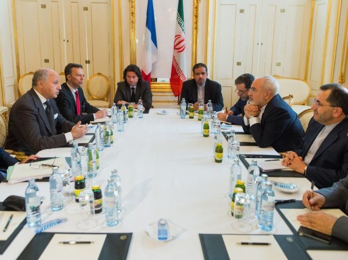 French Foreign Minister Laurent Fabius (L) and Iran's Minister of Foreign Affairs Mohammad Javad Zarif (R) attend a meeting at the Palais Coburg Hotel, the venue of the nuclear talks in Vienna, Austria on June 27, 2015. High-stakes talks to nail down a historic deal with Iran to curtail its nuclear programme may 'slip' past a June 30 deadline, a top US official admitted ahead of crunch weekend negotiations in Vienna. AFP PHOTO / POOL / CHRISTIAN BRUNA