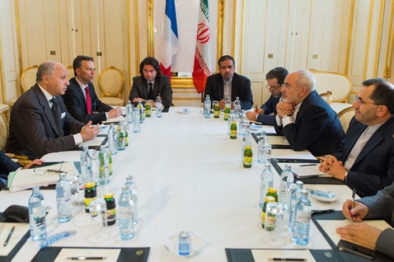 French Foreign Minister Laurent Fabius (L) and Iran's Minister of Foreign Affairs Mohammad Javad Zarif (R) attend a meeting at the Palais Coburg Hotel, the venue of the nuclear talks in Vienna, Austria on June 27, 2015. High-stakes talks to nail down a historic deal with Iran to curtail its nuclear programme may 'slip' past a June 30 deadline, a top US official admitted ahead of crunch weekend negotiations in Vienna. AFP PHOTO / POOL / CHRISTIAN BRUNA