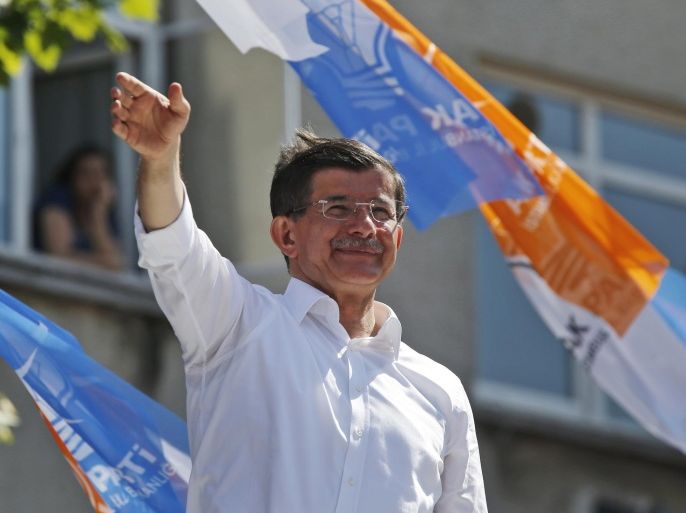 FILE - In this Tuesday, June 2, 2015 file photo,Turkey's Prime Minister and leader of the Justice and Development Party (AKP) Ahmet Davutoglu waves to his supporters following his speech at an election campaign rally in Istanbul, Turkey. Turkish President Recep Tayyip Erdogan's office on Tuesday, June 9, 2015 says he has accepted the resignation of Prime Minister Ahmet Davutoglu's government to allow for the formation of a new government after his ruling party lost its parliamentary majority in a national vote. Erdogan is now expected give Davutoglu the difficult task of forming a coalition government. (AP Photo/Lefteris Pitarakis, file)