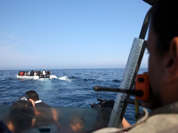 TRIPOLI, LIBYA - JUNE 06: African origin illegal migrants, who wanted to go to Europe, are seen on a boat after being caught by the Coast Guard Forces 18 miles away the Libya coast on June 6, 2015.