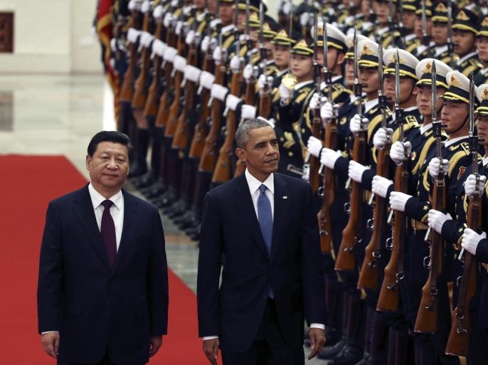 US President Barack Obama (2-L) and Chinese President Xi Jinping (L) review honor guards during a welcome ceremony at the Great Hall of the People (GHOP) in Beijing, China, 12 November 2014. Obama is in China to attend the Asia-Pacific Economic Cooperation (APEC) 2014 Summit and related meetings.