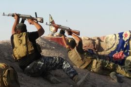 In this photo taken Monday, June 15, 2015, Iraqi security forces defend their positions against Islamic State group attack in Husaybah, 8 kilometers (5 miles) east of Ramadi, Iraq. The Islamic State group still holds about a third of Iraq and Syria, including Iraq's second-largest city, Mosul. IS fighters continue to battle Iraqi security forces and Shiite militiamen for territory. (AP Photo)