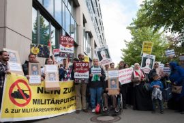 Demonstraters hold placards outside a police station, Berlin, Germany 21 June 2015. A protest of about 60 people calling for the release of Al Jazeera journalist Ahmed Mansour had gathered. The journalist was arrested on 20 June at Berlin-Tegel Airport when he tried to fly to Doha, Qatar. According to the German Federal Police an international arrest warrant was out against him, which had been sent to them. Mansour is one of the most famous television journalists in the Arab world. In 2014 criminal court in Cairo had sentenced him in absentia to 15 years in prison because he allegedly participated in the torture of a lawyer the Arab spring movment of 2011.