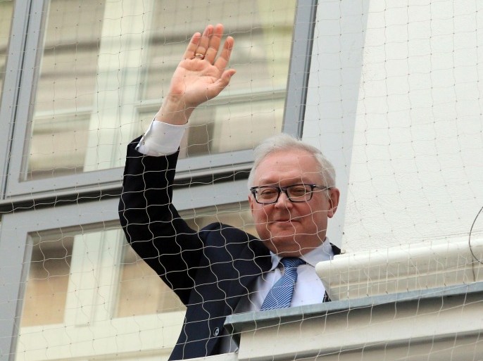 Russian Deputy Foreign Minister Sergei Ryabkov waves from the balcony of Palais Coburg where closed-door nuclear talks with Iran take place in Vienna, Austria, Sunday, Nov.23, 2014. (AP Photo/Ronald Zak)