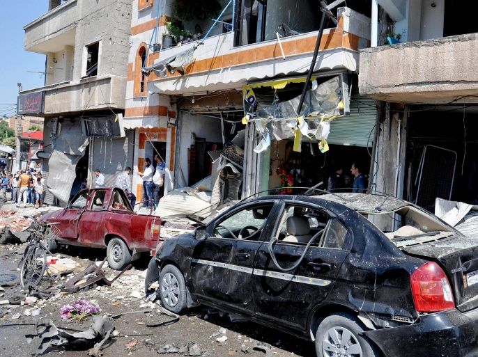 A handout picture made available by official Syrian Arab news agency SANA shows the scene of a car bomb explosion in the Karm Al lawz neighborhood, Homs province, Syria, 14 June 2015. According to local reports 25 wounded when small bus detonated in the Syrian city of Homs.