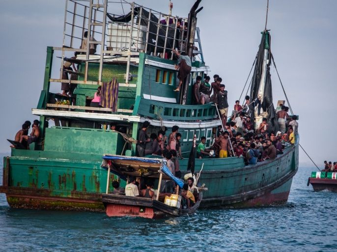 INDONESIA : In this photo taken on May 20, 2015 shows Rohingya migrants resting on a boat off the coast near Kuala Simpang Tiga in Indonesia's East Aceh district of Aceh province before being rescued. Indonesia's foreign minister demanded answers from Canberra about claims Australian officials paid thousands of dollars to turn a boat back to Indonesia after Prime Minister Tony Abbott refused to deny the allegations. AFP PHOTO / JANUAR