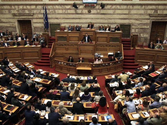 Greek Prime Minister Alexis Tsipras (C) speaks at a debate on the referendum in the plenary session at the Greek Parliament in Athens, Greece, early 28 June 2015. Tsipras called for a referendum on the Greek debt deal on 05 July, during a televised speech late night on 27 June on Greek state TV. Eurozone finance ministers on 27 June rejected a request to extend the European part of Greece's bailout programme beyond 30 June, casting serious doubts on the Mediterranean nation's permanence in the European common currency.