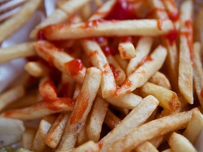 Close up of delicious french fries covered in tasty ketchup in basket
