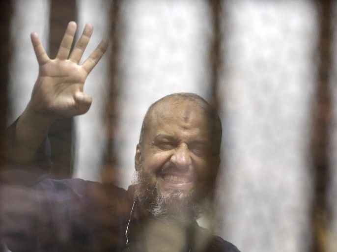 Senior Muslim Brotherhood leader Mohammed el-Beltagy, flashes the four-fingered symbol of Rabaah that refers to the deadly dispersal of supporters of former Egyptian President Mohammed Morsi in August 2013, after he was sentenced to 20 years by a Cairo court, in the Police Academy courthouse in Cairo, Egypt, Tuesday, April 21, 2015. Under the current army chief-turned-politician Abdel-Fattah el-Sissi, thousands of Morsi’s supporters are facing mass trials that end with mass death sentences, sparking international condemnation. (AP Photo/Amr Nabil)