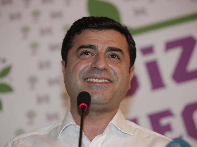 Selahattin Demirtas, co-chair of the pro-Kurdish Peoples' Democratic Party, (HDP) smiles during a news conference in Istanbul, Turkey, late Sunday, June 7, 2015. In a stunning blow to President Recep Tayyip Erdogan, preliminary results from Turkey's parliamentary election on Sunday suggested that his party could lose its simple majority in Parliament. Demirtas called his party's ability to cross the threshold a "fabulous victory for peace and freedoms" that came despite the attack on his party and fierce campaigning by Erdogan. (AP Photo/Lefteris Pitarakis)