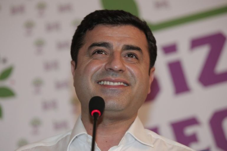 Selahattin Demirtas, co-chair of the pro-Kurdish Peoples' Democratic Party, (HDP) smiles during a news conference in Istanbul, Turkey, late Sunday, June 7, 2015. In a stunning blow to President Recep Tayyip Erdogan, preliminary results from Turkey's parliamentary election on Sunday suggested that his party could lose its simple majority in Parliament. Demirtas called his party's ability to cross the threshold a "fabulous victory for peace and freedoms" that came despite the attack on his party and fierce campaigning by Erdogan. (AP Photo/Lefteris Pitarakis)
