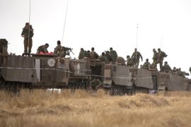 Israeli soldiers stand on armored personal carriers during a training exercise near the Israel-Gaza Border, on June 7, 2015. Israeli warplanes struck Gaza earlier in the day for the second time in three days after cross-border rocket fire by an Islamic extremist group which is locked in a power struggle with Hamas. AFP PHOTO / MENAHEM KAHANA
