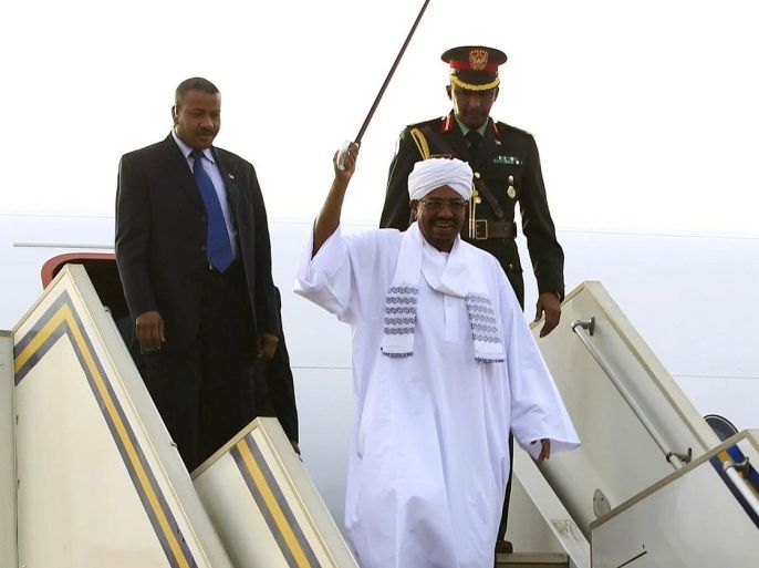 Sudanese President Omar al-Bashir salutes his supporters as he disembarks from the plane, after attending an African Union conference in Johannesburg South Africa, at the airport in the capital Khartoum, June 15, 2015. Al-Bashir flew out of South Africa on Monday in defiance of a Pretoria court that later said he should have been arrested to face genocide charges at the International Criminal Court. Despite a legal order for him to stay in the country ahead of the ruling on his detention, the government let Bashir leave unhindered, with South Africa's ruling party accusing the ICC of being biased against Africans and "no longer useful". REUTERS/Mohamed Nureldin Abdallah