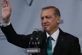 Turkey's President Recep Tayyip Erdogan, waves after his speech following a traditional iftar, the first meal to break the Ramadan fast, during a visit at the Midyat refugee camp in Mardin, southeastern Turkey, near the Syrian border, Saturday, June 20, 2015. Erdogan visited the camp which is sheltering those who have fled the 4-year conflict in neighbouring Syria. The UN refugee agency has said the number of Syrian refugees seeking its help now tops two-million - and could be far higher. Turkey is the world's biggest refugee host with 1.59 million refugees, according to the most recent U.N. figures. (AP Photo/Emrah Gurel)
