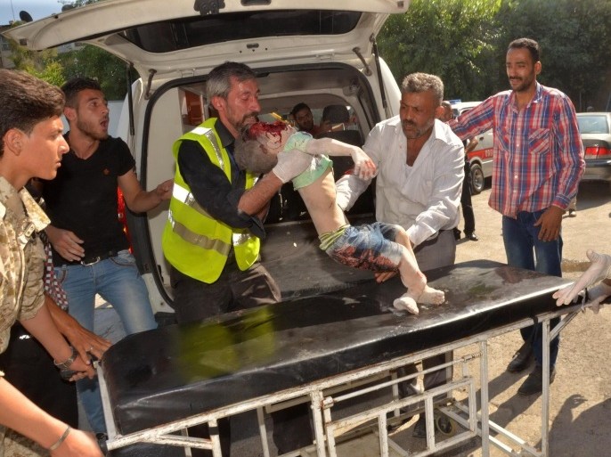GRAPHIC CONTENTMembers of the Syrian emergency services transport a dead child on a stretcher outside al-Razzi hospital after a Syrian rebel rocket reportedly struck a government-held part of the northern Syrian city of Aleppo on June 15, 2015, killing at least 20 people and wounding dozens more. The Syrian Observatory for Human Rights said rebels had fired some 250 rockets at several districts in western Aleppo city in just four hours, causing massive damage including the collapse of an entire building. AFP PHOTO / GEORGE OUFALIAN