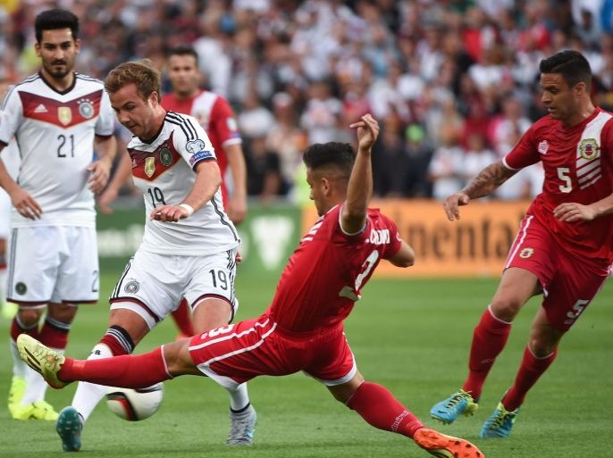 Germany's Mario Goetze (2-L) and Ilkay Guendogan (L) vie with Josepf Chipolina (C) and Ryan Casciaro of Gibraltar for the ball during the UEFA EURO 2016 qualifying group D soccer match Gibraltar vs. Germany at the Algarve Stadium in Faro, Portugal, on 13 June 2015.