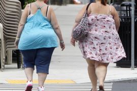 In this June 17, 2013 photo, two women cross the street in Barre, Vt. In its biggest policy change on weight and health to date, the American Medical Association has recognized obesity as a disease.