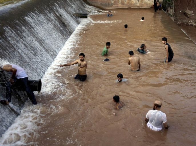 Pakistani youths cool off themselves at a river on the outskirts of Islamabad, Pakistan, Sunday, June 21, 2015. Many cities in Pakistan are facing heat wave conditions with temperatures reaching 49 degrees Celsius (120.2 Fahrenheit). (AP Photo/Anjum Naveed)
