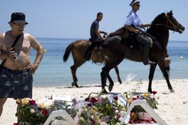 Sousse, -, TUNISIA : Tunisian policemen patrol the beach in front of the Riu Imperial Marhaba Hotel in Port el Kantaoui, on the outskirts of Sousse south of the capital Tunis, on June 28, 2015, following a shooting attack two days earlier. In April, tourism saw a 25.7 percent drop in the number of visitors on the same month in 2014 and a 26.3 percent fall in revenues, according to the Tunisian central bank. AFP PHOTO / KENZO TRIBOUILLARD