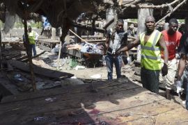 Rescue workers at the site of a suicide bomb attack at a market in Maiduguri , Nigeria, Tuesday, June 2, 2015. Boko Haram attacked the northeastern Nigerian city of Maiduguri on Tuesday with deafening explosions from the west and a suicide bombing near the center that witnesses said killed as many as 20 people. (AP Photo/Jossy Ola)