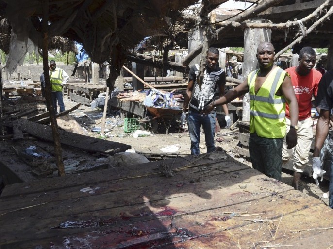 Rescue workers at the site of a suicide bomb attack at a market in Maiduguri , Nigeria, Tuesday, June 2, 2015. Boko Haram attacked the northeastern Nigerian city of Maiduguri on Tuesday with deafening explosions from the west and a suicide bombing near the center that witnesses said killed as many as 20 people. (AP Photo/Jossy Ola)