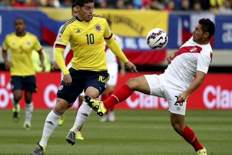 Colombia's James Rodriguez (L) in action against Peru's Joel Melchor Sanchez during the Copa America 2015 Group C soccer match between Colombia and Peru, at Estadio Municipal Bicentenario German Becker in Temuco, Chile, 21 June 2015.