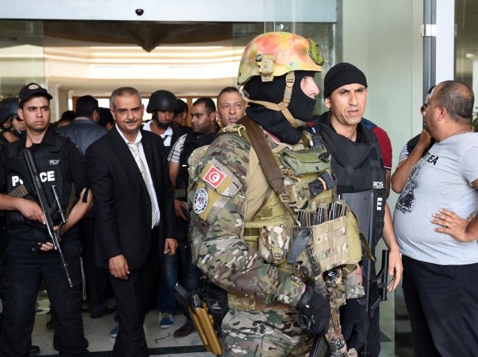 Tunisian security forces stand in front of the Imperial hotel in the resort town of Sousse, a popular tourist destination 140 kilometres (90 miles) south of the Tunisian capital, on June 26, 2015, following a shooting attack. At least 27 people, including foreigners, were killed in a mass shooting at a Tunisian beach resort packed with holidaymakers, in the North African country's worst attack in recent history. AFP PHOTO / FETHI BELAID