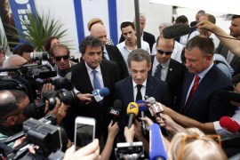 Former French president Nicolas Sarkozy (C) and leader of France's main opposition right-wing party Les Republicains (formerly known as the UMP), answers journalists' questions in Jerusalem, on June 8, 2015. During his visit, Sarkozy is expected to meet with Israeli Prime Minister Benjamin Netanyahu and Palestinian president Mahmud Abbas before addressing the annual Herzliya security conference. On the left is former French minister and MP, Pierre Lelouch. AFP PHOTO / THOMAS COEX