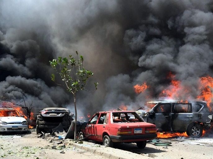 Smoke and flames rise above a burning cars at the scene of a bombing targeting the convoy of the Egyptian Prosecutor General, in a northern suburb of Heliopolis, Cairo, Egypt, 29 June 2015. According to reports Egypt's Prosecutor General, Hisham Barakat, is receiving treatment in hospital for injuries to his face and shoulder. Two of his guards and a civilian were also injured in the incident on Barakat's route between his office and home which left at least five cars destroyed. In an uncorroborated statement the group calling themselves the Giza Popular Resistance have claimed responsibility.
