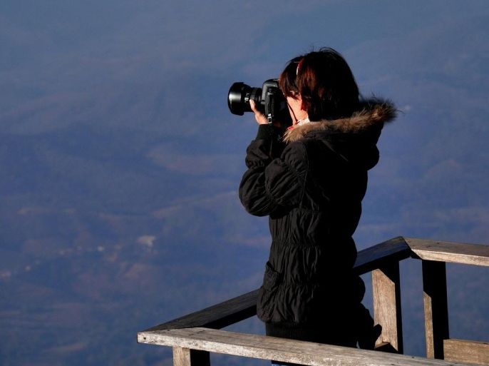High Angle View Of Woman Taking Picture From Digital Camera