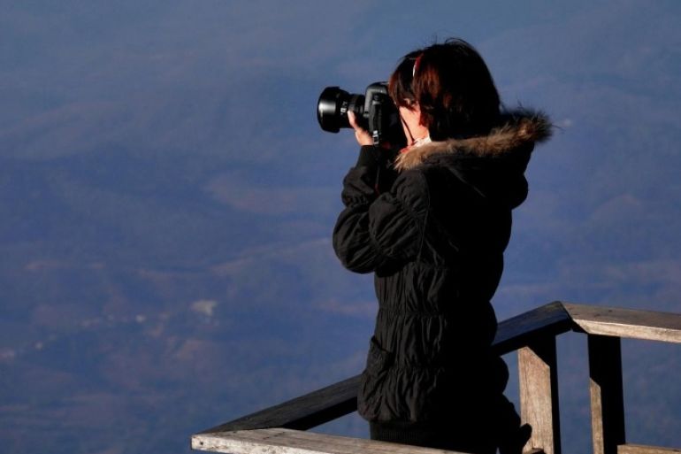 High Angle View Of Woman Taking Picture From Digital Camera