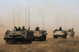 Israeli soldiers ride armoured vehicles during an exercise in the Israeli-occupied Golan Heights, near the ceasefire line between Israel and Syria June 17, 2015. Israel signaled readiness on Tuesday to intervene if Syrian refugees were to throng to its armistice line on the Golan Heights, after Israel's Druze Arab minority stepped up a public campaign to help brethren caught up in the civil war next door. REUTERS/Baz Ratner