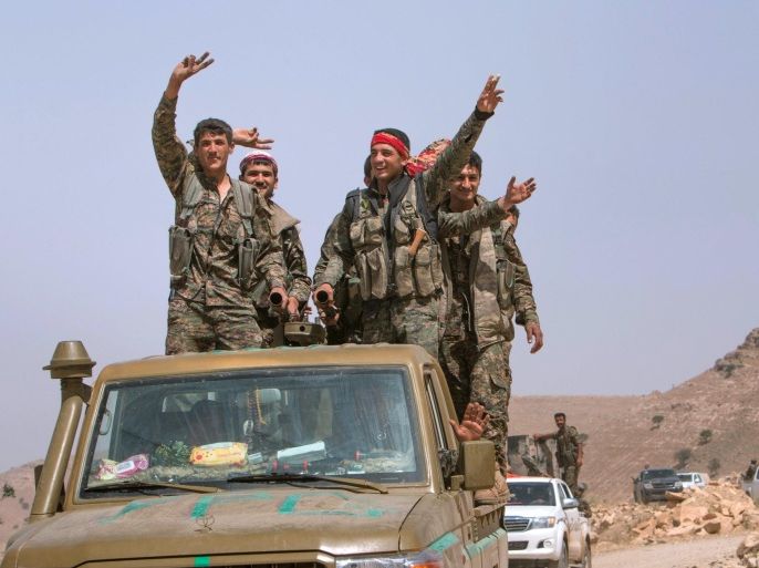 Kurdish People's Protection Units (YPG) fighters gesture while riding on their vehicle on Abd al-Aziz mountain, Hasaka province, after they said they took control of the area May 20, 2015. Kurdish People's Protection Units (YPG) took control of Abd al-Aziz mountain from Islamic state fighters, after clashes that lasted for several days, activists said. Picture taken May 20, 2015. REUTERS/Rodi Said