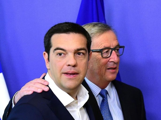 Greece's Prime Minister Alexis Tsipras (L) is welcomed by European Commission President Jean-Claude Juncker ahead of an emergency eurozone summit on Greece at the European Commission in Brussels, on June 22, 2015. The European Central Bank (ECB) again increased emergency liquidity funds for Greece's banks on June 22, according to a Greek bank source who said the ECB may renew the hike 'at any time' if necessary. AFP PHOTO / EMMANUEL DUNAND