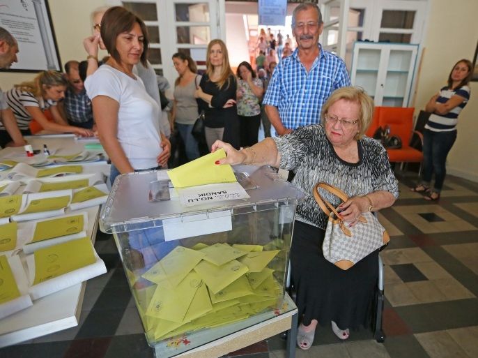 IZMIR, TURKEY - JUNE 07: A woman casts her ballot in the Turkish general election at a polling station in Izmir, Turkey on June 07, 2015. More than 53.7 million Turks are eligible to vote in a poll to elect 550 deputies to the Grand National Assembly.