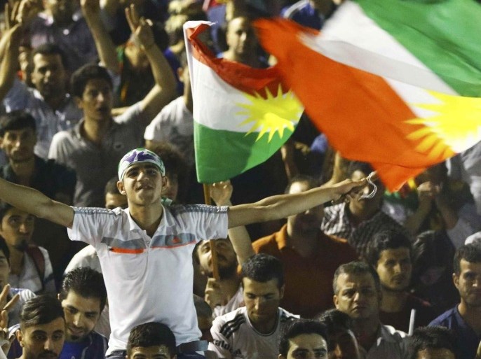 Supporters wave Kurdish flags as they celebrate outside the pro-Kurdish Peoples' Democratic Party (HDP) headquarters in Diyarbakir, Turkey, June 7, 2015. Thousands of jubilant Kurds flooded the streets of Turkey's southeastern city of Diyarbakir on Sunday, setting off fireworks and waving flags as the pro-Kurdish opposition looked likely to enter parliament as a party for the first time. REUTERS/Osman Orsal
