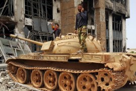 Members of the Libyan pro-government forces stand on a tank in Benghazi, Libya, May 21, 2015. Libya, which has descended into near anarchy since NATO warplanes helped rebels overthrow former dictator Muammar Gaddafi in a 2011 civil war, is now the third big stronghold for Sunni Islamist group Islamic State, also known as ISIS or ISIL, which declared a Caliphate to rule over all Muslims from territory it holds in Syria and Iraq. REUTERS/Stringer