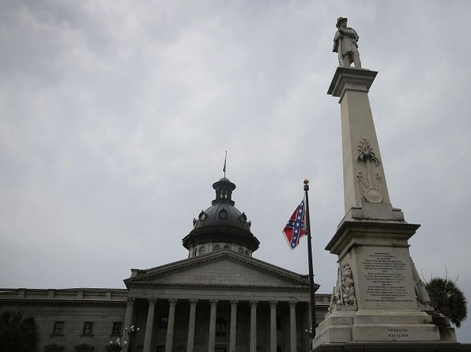 COLUMBIA, SC - JUNE 22: The Confederate flag flies on the Capitol grounds after South Carolina Gov. Nikki Haley announced that she will call for the Confederate flag to be removed on June 22, 2015 in Columbia, South Carolina. Debate over the flag flying at the Capitol was again ignited off after nine people were shot and killed during a prayer meeting at the Emanuel African Methodist Episcopal Church in Charleston, South Carolina.