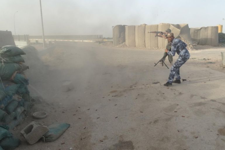 In this Thursday, June 4, 2015 photo, Iraqi Federal police and Shiite Hezbollah Brigade militiamen fight against the Islamic State group as they defend their positions on the front line in eastern Husaybah, 8 kilometers (5 miles) east of Ramadi, Iraq. (AP Photo)